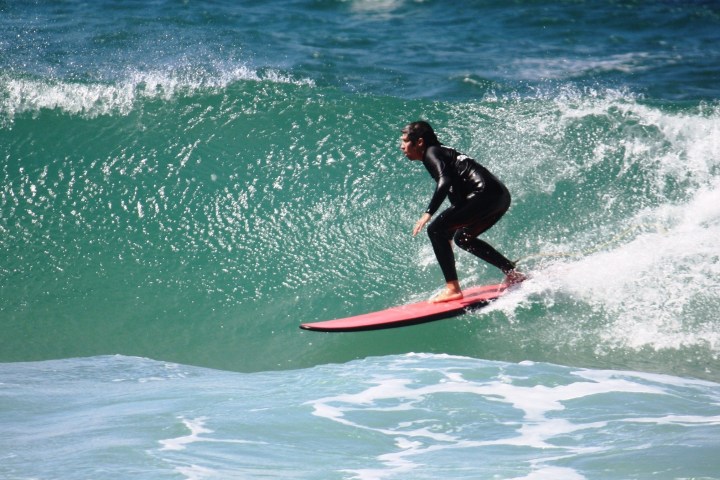 a person riding a wave on a surfboard in the ocean